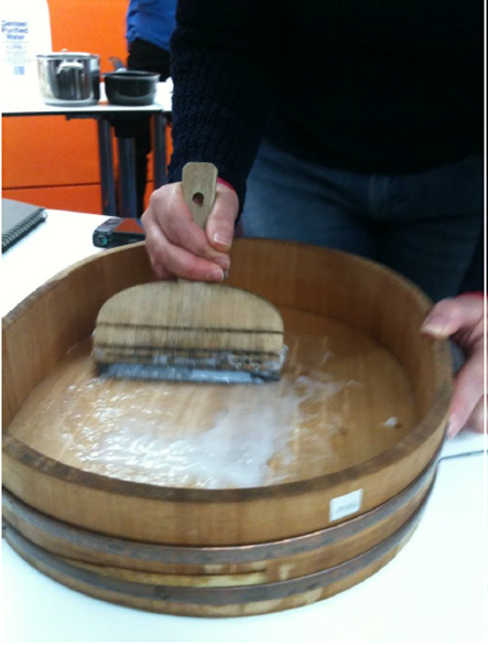 Starch Paste being worked up by participant using traditional method. Note the hand and finger position on the brush.