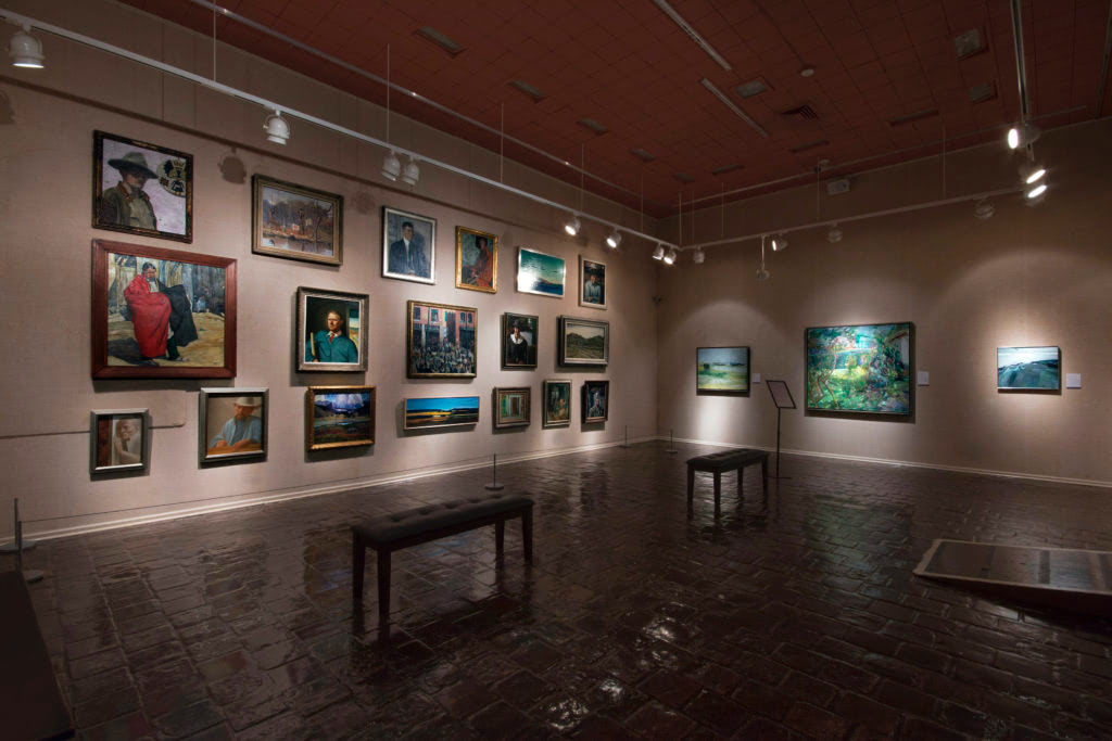 A Salon-style wall at The Society of the Four Arts depicts landscapes and their makers. Photo courtesy of Christopher Fey.