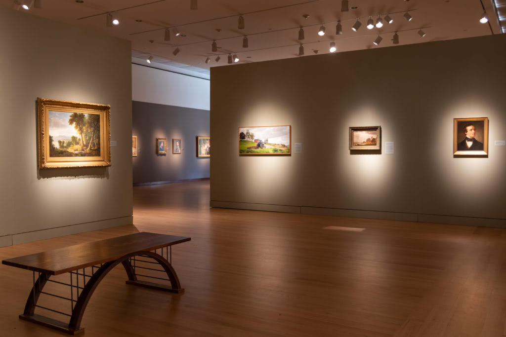 A gallery at New Britain Museum of American Art presents single paintings from different time periods side-by-side.