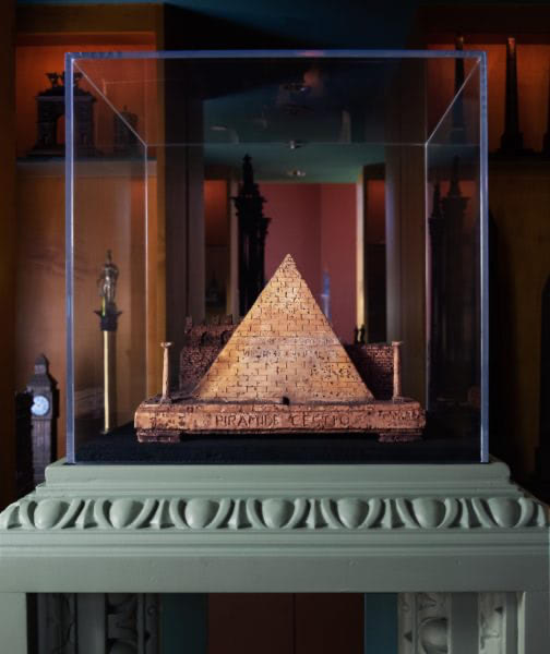A smaller, earlier, carved cork model in Piraneseum's collection, whose subject is Rome's Pyramid of Caius Cestius. This highly-wrought replica (note the Latin text on the sloping masonry face) dates to the late 18th century. Its maker is, as yet, unidentified. While there were a couple of relatively large Roman studios in this period making cork architectural models, there was also an abundance of small, anonymous shops. The Optium Museum Acrylic® cube is intended as a counterpoint to the ancient monument's strict geometry.