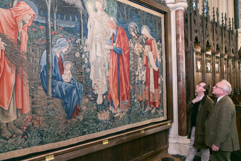 Exeter Chapel's bursar William Jensen and Reverend Andrew Allen admire the tapestry in its new frame prior to installation of the glazing. Image:
Studio8 Ltd.