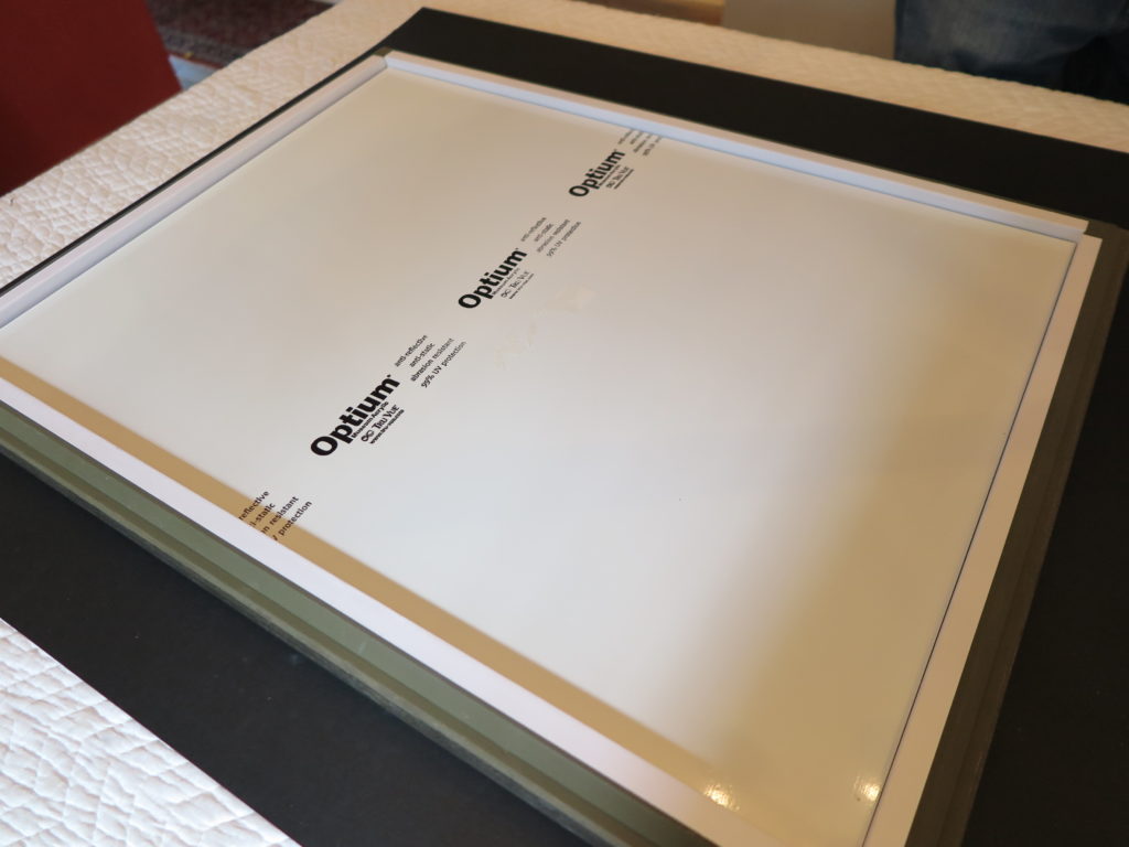 Protective Optium Museum Acrylic glazing installed inside a frame for artwork preservation.