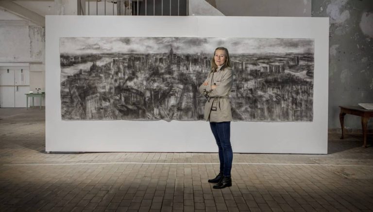 Torild Stray with "New York Metamorphosis" pinned to gallery wall, Courtesy of Torild Stray.