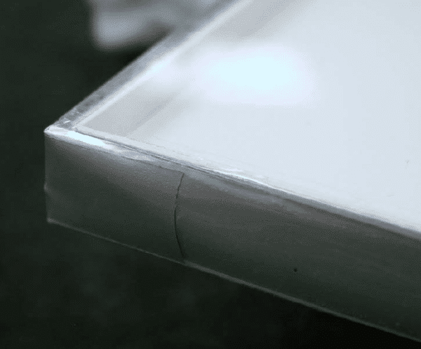 A completed, hermetically sealed framing package using glass glazing, suitable for humidity-sensitive artwork.