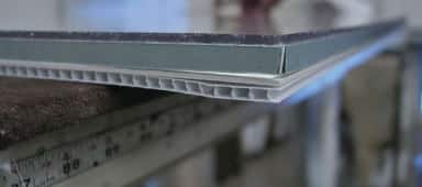 Components of a standard picture framing package, including glazing, matting, artwork, and backing.