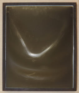 Close-up of fire-damaged frames from the LaSalle Bank Headquarters fire in 2004, showing melted and bowed Plexiglas glazing that protected the photographs inside.