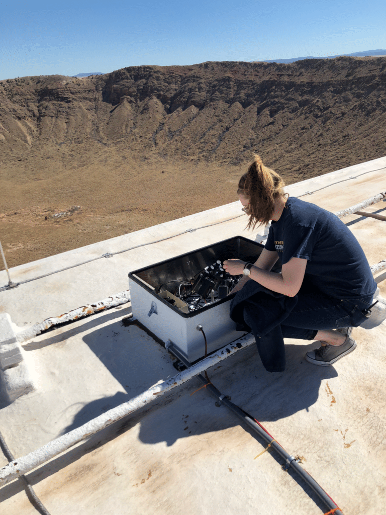Technician working with Tru Vue UltraVue laminated glass during installation at Solvay facility