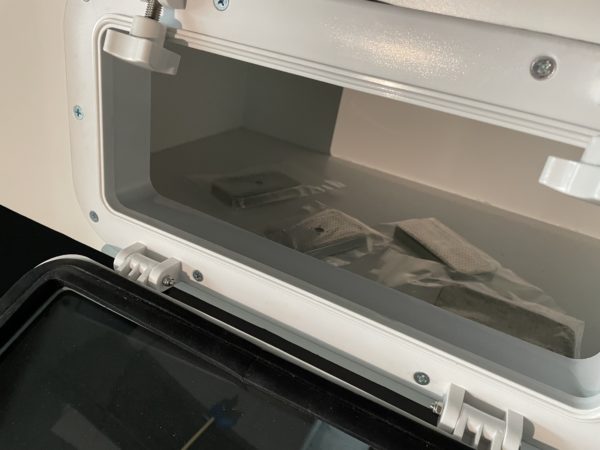 Interior desiccant tray accessible through a portal hole in display case. Photo courtesy of MoPOP