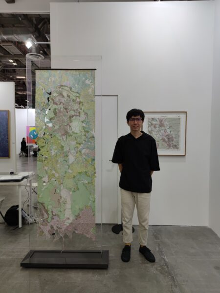 the aesthetics of presentation artist Zelin Seah next to his work, Where Have All The ( ) Gone