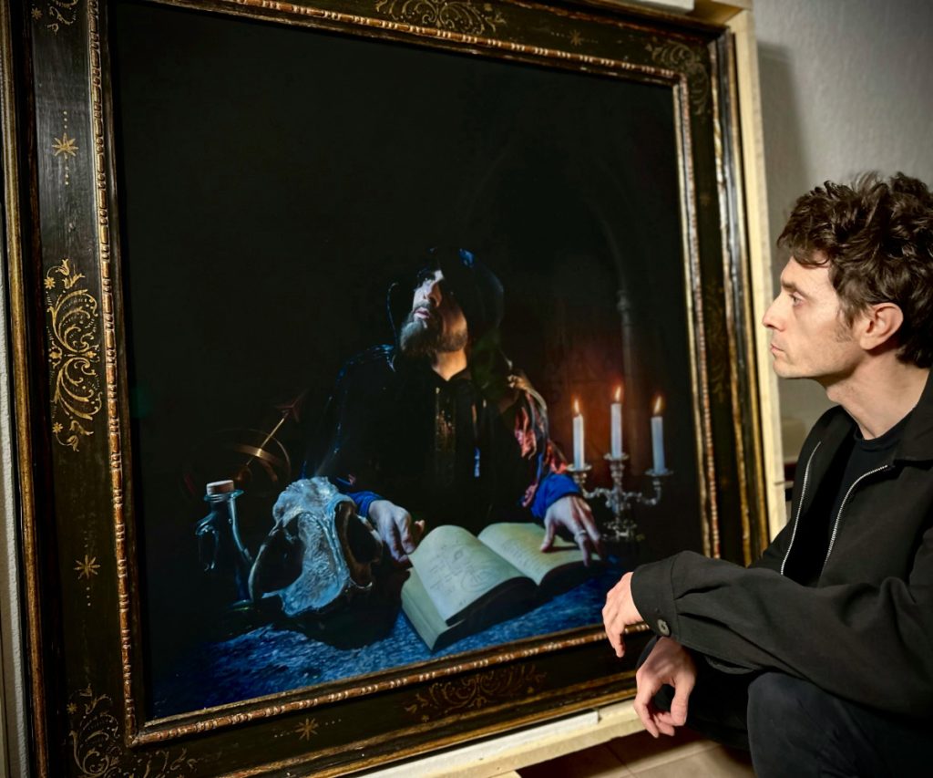 Artist viewing a framed pastel artwork protected with Tru Vue® Optium Museum Acrylic®, demonstrating exceptional clarity and reduced reflections.